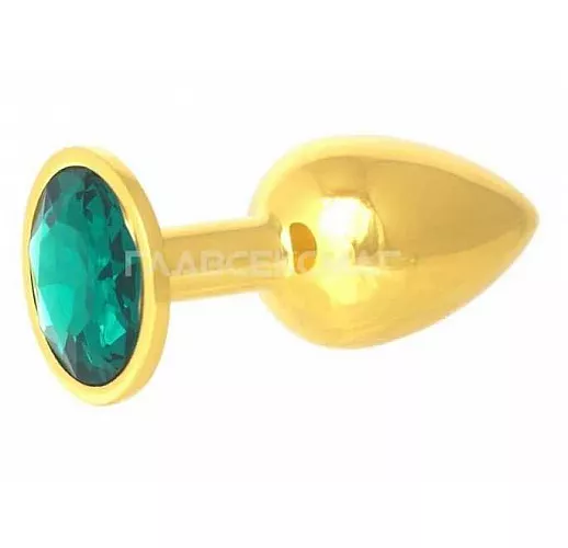 Золотистая анальная пробка с зелёным кристаллом - 7 см. Золотистая анальная пробка с зелёным кристаллом - 7 см.